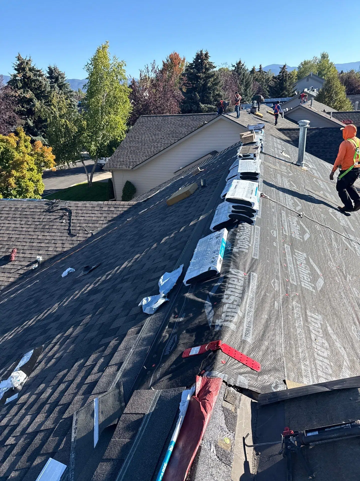Burish Builder TN providing Residential Roofing Services, shown with a crew working on a roof, preparing it for new shingles.
